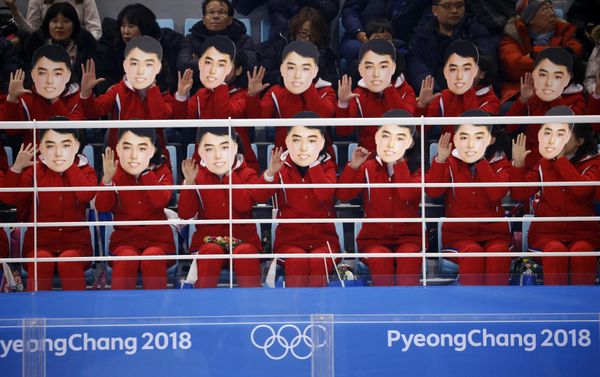 Ice Hockey – Pyeongchang 2018 Winter Olympics – Women Preliminary Round Match - Switzerland v Korea - Kwandong Hockey Centre, Gangneung, South Korea – February 10, 2018 - North Korea's cheer squad hold masks - Sputnik International