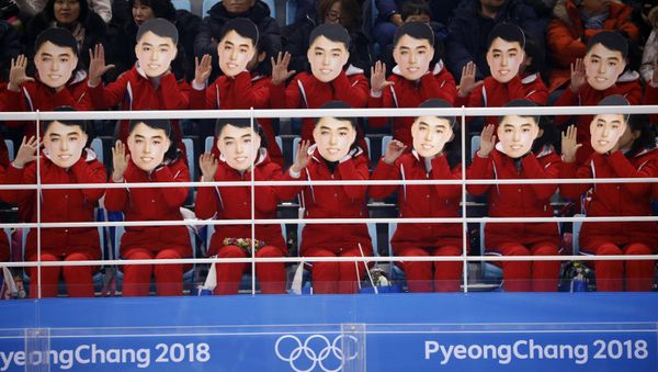 Ice Hockey – Pyeongchang 2018 Winter Olympics – Women Preliminary Round Match - Switzerland v Korea - Kwandong Hockey Centre, Gangneung, South Korea – February 10, 2018 - North Korea's cheer squad hold masks - Sputnik International
