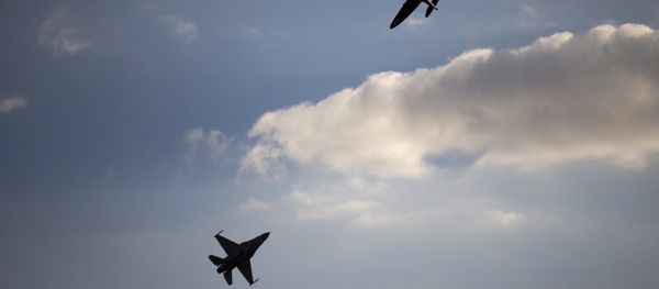 An Israeli Air Force F-16 plane, bottom, and an Israeli Air force Spitfire plane perform during a graduation ceremony for new pilots in the Hatzerim air force base near the city of Beersheba, Israel. (File) - Sputnik International