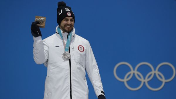 Medals Ceremony - Luge - Pyeongchang 2018 Winter Olympics - Men's Singles - Medals Plaza - Pyeongchang, South Korea - February 12, 2018 - Silver medalist Chris Mazdzer of the U.S on the podium. - Sputnik International
