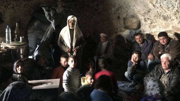 Residents of the Kurdish township of Jenderes in Afrin region in the north of Syria who fled from shellings by the Turkish Army are hiding in the caves in Haltan village - Sputnik International