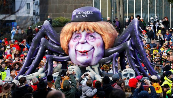 A carnival float shows Christian Democratic Union (CDU) leader and German Chancellor Angela Merkel as black widow at the traditional Rosenmontag Rose Monday carnival parade in Duesseldorf, Germany, February 12, 2018 A carnival float shows Christian Democratic Union (CDU) leader and German Chancellor Angela Merkel as black widow at the traditional Rosenmontag Rose Monday carnival parade in Duesseldorf, Germany, February 12, 2018 - Sputnik International