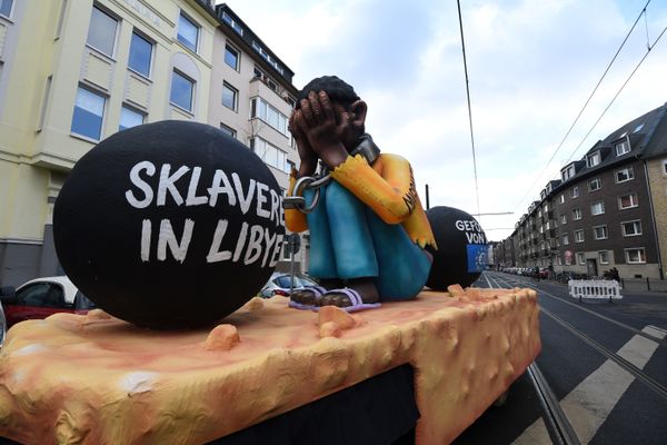 A carnival float, depicting a migrant with chains with the writings Slavery in Libya and supported by the EU, is pictured during a carnival parade on Rose Monday on February 12, 2018 in Duesseldorf, western Germany A carnival float, depicting a migrant with chains with the writings Slavery in Libya and supported by the EU, is pictured during a carnival parade on Rose Monday on February 12, 2018 in Duesseldorf, western Germany - Sputnik International