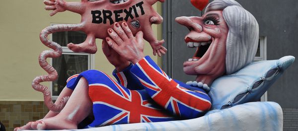 A float depicts British Prime Minister Theresa May looking at her Brexit-baby during the traditional Rose Monday parade in Duesseldorf, Germany - Sputnik International
