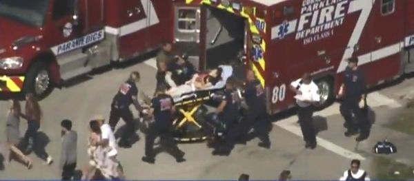Rescue workers prepare to transport a victim on a stretcher near Marjory Stoneman Douglas High School following a shooting incident in Parkland, Florida, U.S. February 14, 2018 in this still image taken from a video Rescue workers prepare to transport a victim on a stretcher near Marjory Stoneman Douglas High School following a shooting incident in Parkland, Florida, U.S. February 14, 2018 in this still image taken from a video - Sputnik International
