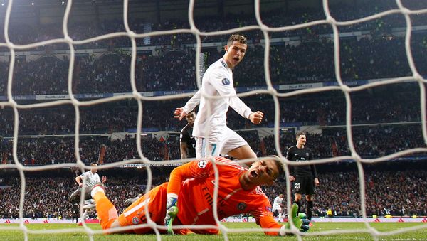 Soccer Football - Champions League Round of 16 First Leg - Real Madrid vs Paris St Germain - Santiago Bernabeu, Madrid, Spain - February 14, 2018 Real Madrid’s Cristiano Ronaldo celebrates after Marcelo scores their third goal as Paris Saint-Germain’s Alphonse Areola looks dejected - Sputnik International