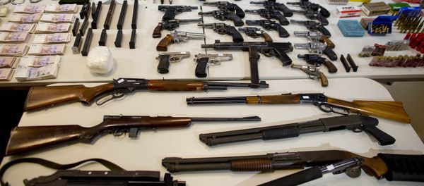 Weapons that were seized during an anti-drug raid, are displayed on a table for a media presentation in Buenos Aires, Argentina, Friday, May 16, 2014 Weapons that were seized during an anti-drug raid, are displayed on a table for a media presentation in Buenos Aires, Argentina, Friday, May 16, 2014 - Sputnik International