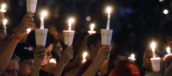 Attendees raise their candles at a candlelight vigil for the victims of the shooting at Marjory Stoneman Douglas High School, Thursday, Feb. 15, 2018, in Parkland, Fla. - Sputnik International