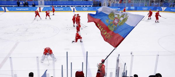 A Russian fan waves a flag before the ice hockey game between teams of Russia and the US at the 2018 Winter Olympics, February 17, 2018 - Sputnik International