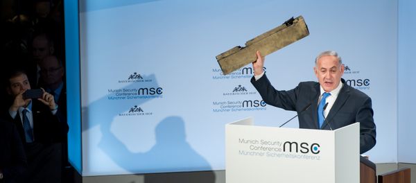 Israeli Prime Minister Benjamin Netanyahu holds up a remnant of what he said was a piece of Iranian drone which was shot down in Israeli airspace during his speech at the Munich Security Conference, Germany February 18, 2018 - Sputnik International
