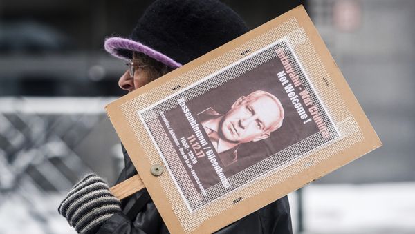 A woman holds a banner as she protests during a visit of Israeli Prime Minister Benjamin Netanyahu's at the EU headquarters in Brussels - Sputnik International