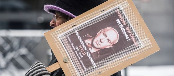 A woman holds a banner as she protests during a visit of Israeli Prime Minister Benjamin Netanyahu's at the EU headquarters in Brussels A woman holds a banner as she protests during a visit of Israeli Prime Minister Benjamin Netanyahu's at the EU headquarters in Brussels - Sputnik International