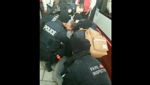 Canadian officials launch investigation after footage of teenager being pinned to the ground and handcuffed by fare inspectors surfaces online - Sputnik International