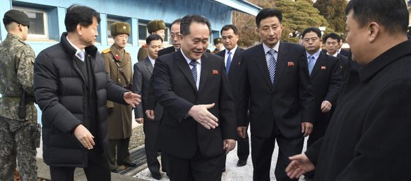 Head of North Korean delegation Ri Son Gwon, center, is greeted by South Korean officials after he crosses the border line to attend their meeting at Panmunjom in the Demilitarized Zone in Paju, South Korea, Tuesday, Jan. 9, 2018 - Sputnik International