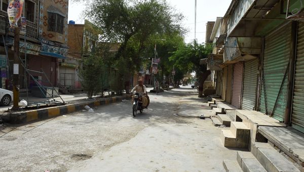 Pakistani motorcyclist drives through a closed market during a hot day in Sibi, in Pakistan's southwestern Balochistan province. (File) Pakistani motorcyclist drives through a closed market during a hot day in Sibi, in Pakistan's southwestern Balochistan province. (File) - Sputnik International