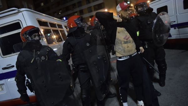 Basque riot police controls a follower of FC Spartak Moskva before the match during the Europa League - round of 32, 2nd leg, between Athletic Bilbao and FC Spartak Moskva, at San Mames stadium, in Bilbao, northern Spain, Thursday, Feb.22, 2018. - Sputnik International