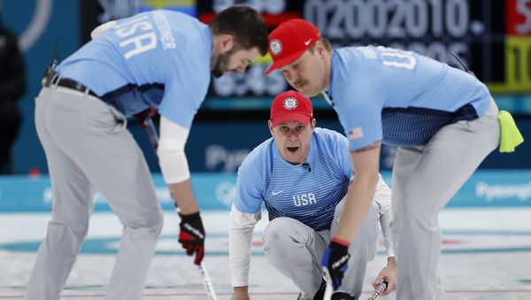 Curling - Pyeongchang 2018 Winter Olympics - Men's Final - Sweden v U.S. - Gangneung Curling Center - Gangneung, South Korea - February 24, 2018 - Skip John Shuster of the U.S. watches the shot as his teammates, lead John Landsteiner and second Matt Hamilton, sweep - Sputnik International