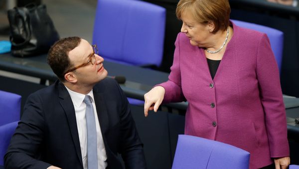 Chancellor Angela Merkel talks to Jens Spahn during debate at the German lower house of parliament Bundestag in Berlin, Germany, February 22, 2018 - Sputnik International