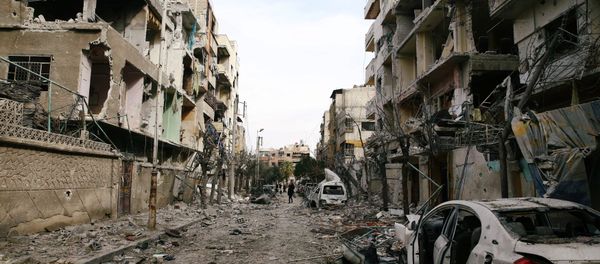Damaged buildings are seen in the besieged town of Douma, Eastern Ghouta, Damascus, Syria February 25, 2018 Damaged buildings are seen in the besieged town of Douma, Eastern Ghouta, Damascus, Syria February 25, 2018 - Sputnik International