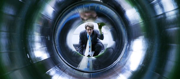 A man looks into a tube representing a natural gas pipeline at the booth of Nord Stream at the Hanover industrial fair in Hanover, Germany (File) - Sputnik International