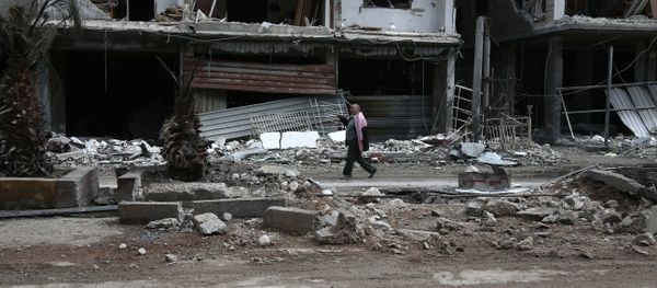 A Syrian man walks past destroyed buildings in the rebel-held town of Haza, in the besieged Eastern Ghouta region on the outskirts of the capital Damascus A Syrian man walks past destroyed buildings in the rebel-held town of Haza, in the besieged Eastern Ghouta region on the outskirts of the capital Damascus - Sputnik International