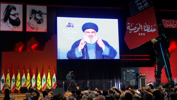 Lebanon's Hezbollah leader Sayyed Hassan Nasrallah is seen on a video screen as he addresses his supporters in Beirut, Lebanon February 16, 2018 - Sputnik International