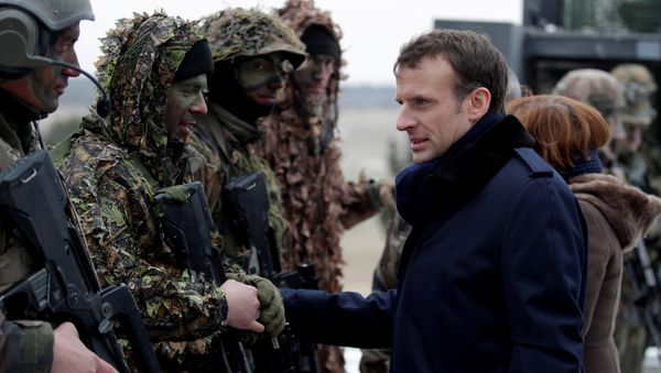 French President Emmanuel Macron speaks with soldiers wearing camouflage as he attends a military exercise at the military camp of Suippes, near Reims, France, March 1, 2018 French President Emmanuel Macron speaks with soldiers wearing camouflage as he attends a military exercise at the military camp of Suippes, near Reims, France, March 1, 2018 - Sputnik International