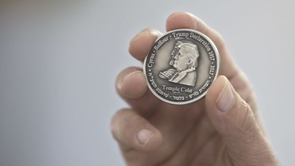 Head of the Mikdash Educational Center, Rabbi Mordecahi Persoss, holds a coin they minted bearing President Donald Trump's image to honor his recognition of Jerusalem as Israel's capital, in Tel Aviv, Israel, Wednesday, Feb. 28, 2018. - Sputnik International