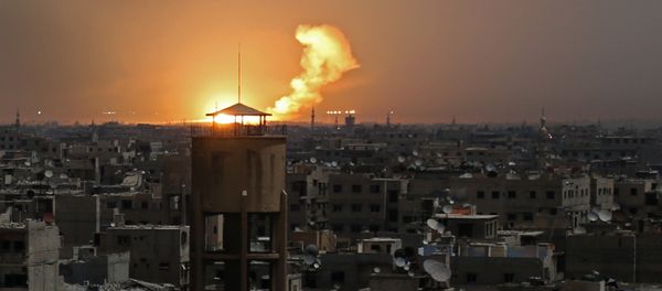 A picture taken on February 28, 2018 shows flames erupting in the horizon following a reported rocket attack in al-Shaffuniyah, in the enclave of Eastern Ghouta on the outskirts of the Syrian capital Damascus A picture taken on February 28, 2018 shows flames erupting in the horizon following a reported rocket attack in al-Shaffuniyah, in the enclave of Eastern Ghouta on the outskirts of the Syrian capital Damascus - Sputnik International