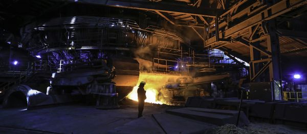 A steelworker watches as molten steel pours from one of the Blast Furnaces during 'tapping' at the British Steel - Scunthorpe plant in north Lincolnshire, north east England. (File) A steelworker watches as molten steel pours from one of the Blast Furnaces during 'tapping' at the British Steel - Scunthorpe plant in north Lincolnshire, north east England. (File) - Sputnik International