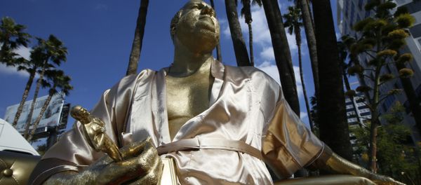A golden statue of a bathrobe-clad Harvey Weinstein, seated almost regally atop a couch holding a fake Oscar Statuette, takes up temporary sidewalk residence four days before the Oscars on Hollywood Blvd. in Los Angeles Thursday, March 1, 2018. - Sputnik International