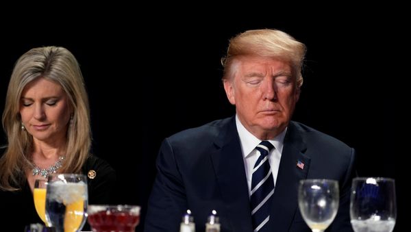 U.S. President Donald Trump (R) bows his head in prayer during the National Prayer Breakfast in Washington, U.S. February 8, 2018 - Sputnik International