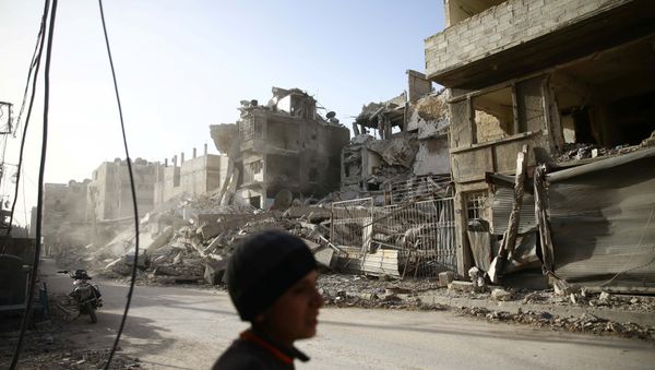 A boy walks near damaged buildings in the besieged town of Douma in eastern Ghouta in Damascus, Syria, March 1, 2018 A boy walks near damaged buildings in the besieged town of Douma in eastern Ghouta in Damascus, Syria, March 1, 2018 - Sputnik International