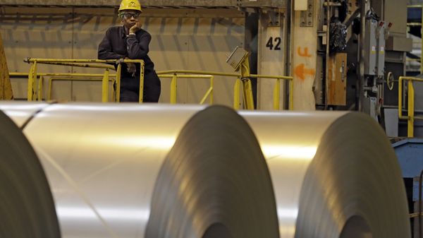 An employee looks on from behind coils of steel as acting Secretary of Labor Seth Harris speaks to workers after a tour of ArcelorMittal Steel's hot dip galvanizing line in Cuyahoga Heights, Ohio (File) - Sputnik International