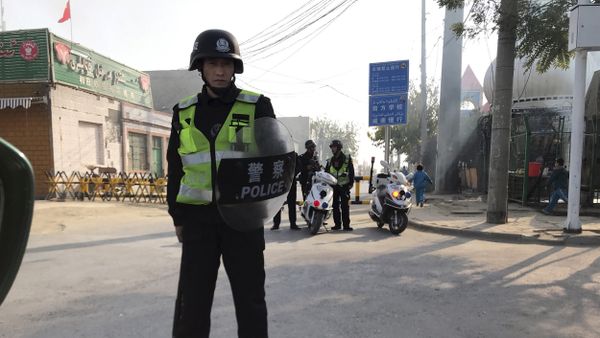 (File) In this Nov. 2, 2017 photo, a police personnel holding shield and baton guards a security post leading into a center believed to be used for re-education in Korla in western China's Xinjiang region (File) In this Nov. 2, 2017 photo, a police personnel holding shield and baton guards a security post leading into a center believed to be used for re-education in Korla in western China's Xinjiang region - Sputnik International