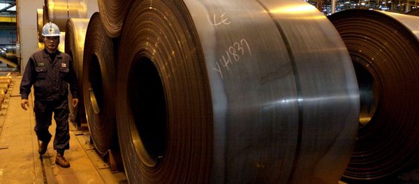 A worker walks by rolls of steel products at Posco steel mill in Pohang, south of Seoul, South Korea, Friday, Dec. 5, 2003 - Sputnik International