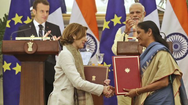 Indian Prime Minister Narendra Modi, top right, and French President Emmanuel Macron, top left, watch as Indian Defense minister Nirmala Sitharaman, right, exchanges agreement files between India and France regarding the provision of reciprocal logistics support between their Armed Forces with France minister of Armed Forces, Florence Parly, in New Delhi, India, Saturday, March 10, 2018 - Sputnik International