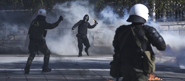 A masked protester throws a molotov cocktail at riot policemen during clashes outside the University of Thessaloniki campus, in Thessaloniki, Greece Saturday March 10, 2018 - Sputnik International