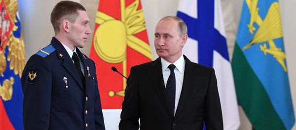 President Vladimir Putin and Gefr. Denis Portnyagin, left, at a ceremony to present state awards to the Russian service personnel who took part in the counter-terrorism operation in the Syrian Arab Republic. File photo - Sputnik International