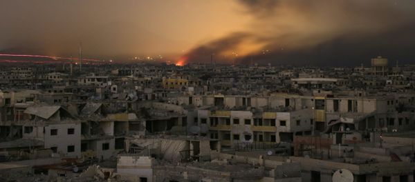 Lights and smoke are seen during Syrian government bombardment on the rebel-controlled town of Arbin, in the besieged Eastern Ghouta region on the outskirts of the capital Damascus, on late March 11, 2018 Lights and smoke are seen during Syrian government bombardment on the rebel-controlled town of Arbin, in the besieged Eastern Ghouta region on the outskirts of the capital Damascus, on late March 11, 2018 - Sputnik International