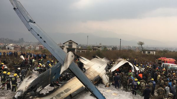 Nepalese rescuers stand near a passenger plane from Bangladesh that crashed at the airport in Kathmandu, Nepal, Monday, March 12, 2018 Nepalese rescuers stand near a passenger plane from Bangladesh that crashed at the airport in Kathmandu, Nepal, Monday, March 12, 2018 - Sputnik International