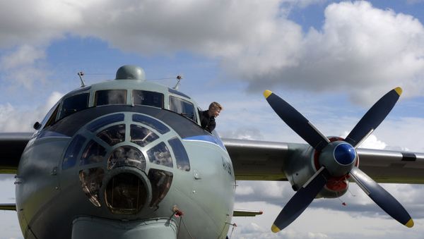 A boy looks out from the cabin of AN-12 Russian military cargo airplane during celebrations for Russian Air Force Day in Pushkin, outside of Saint Petersburg, on August 12, 2016 - Sputnik International