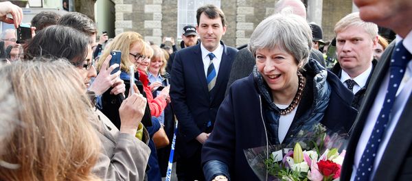 Britain's Prime Minister Theresa May greets people after visiting the scene where former Russian intelligence officer Sergei Skripal and his daughter Yulia were found after they were poisoned with a nerve agent, in Salisbury, Britain March 15, 2018 - Sputnik International
