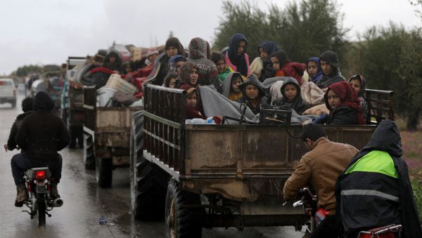 People sit in a truck with their belongings in the north east of Afrin, Syria March 15, 2018 People sit in a truck with their belongings in the north east of Afrin, Syria March 15, 2018 - Sputnik International