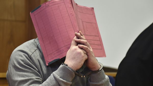 In this Feb. 26, 2015 file photo former nurse Niels Hoegel., accused of multiple murder and attempted murder of patients, covering his face with a file at the district court in Oldenburg, Germany In this Feb. 26, 2015 file photo former nurse Niels Hoegel., accused of multiple murder and attempted murder of patients, covering his face with a file at the district court in Oldenburg, Germany - Sputnik International