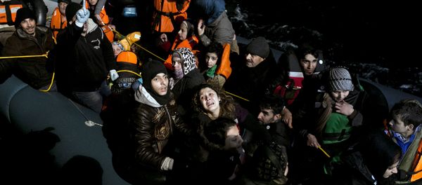 (File) Refugees and migrants aboard an inflatable dinghy are about to be rescued by MOAS (Migrant Offshore Aid Station) while attempting to reach the Greek island of Agathonisi, Dodecanese, southeastern Agean Sea, overnight on January 16, 2016 - Sputnik International