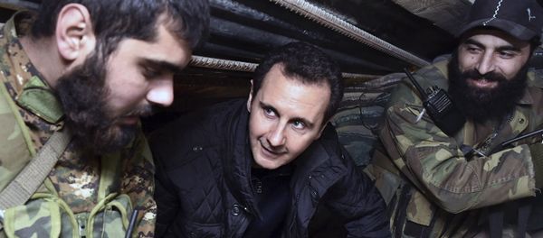 (File) This Wednesday, Dec. 31, 2014, file photo released by the Syrian official news agency SANA, Syrian President Bashar Assad, center, speaks with Syrian troops during his visit to the front line in the eastern Damascus district of Jobar, Syria - Sputnik International