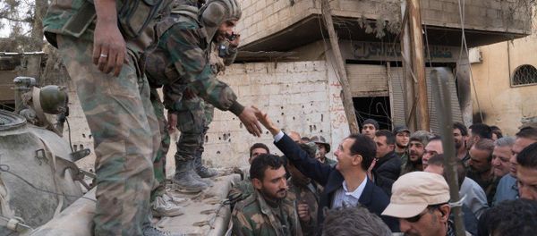 Syrian President Bashar al-Assad reaches out to shake the hand of a Syrian army soldier in eastern Ghouta, Syria, March 18, 2018 Syrian President Bashar al-Assad reaches out to shake the hand of a Syrian army soldier in eastern Ghouta, Syria, March 18, 2018 - Sputnik International