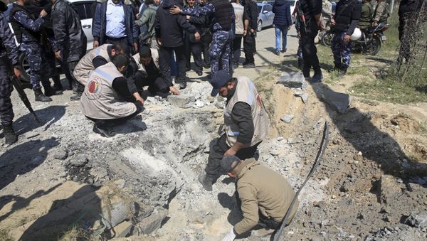 Hamas security services personnel inspect the site of a Tuesday explosion that occurred as the convoy of Palestinian Prime Minister Rami Hamdallah entered Gaza through the Erez crossing with Israel, on the main road in Beit Hanoun, Gaza Strip, Tuesday, March 13, 2018 - Sputnik International