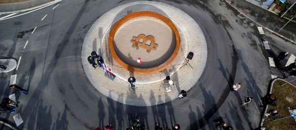 People attend the opening ceremony of world's first public Bitcoin monument, placed at a roundabout connecting two roads at the city centre in Kranj, Slovenia, March 13, 2018 - Sputnik International